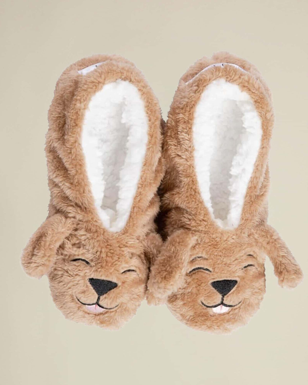 A pair of brown plush slippers designed to resemble a dog with the text 'Dog Tired' on the back.