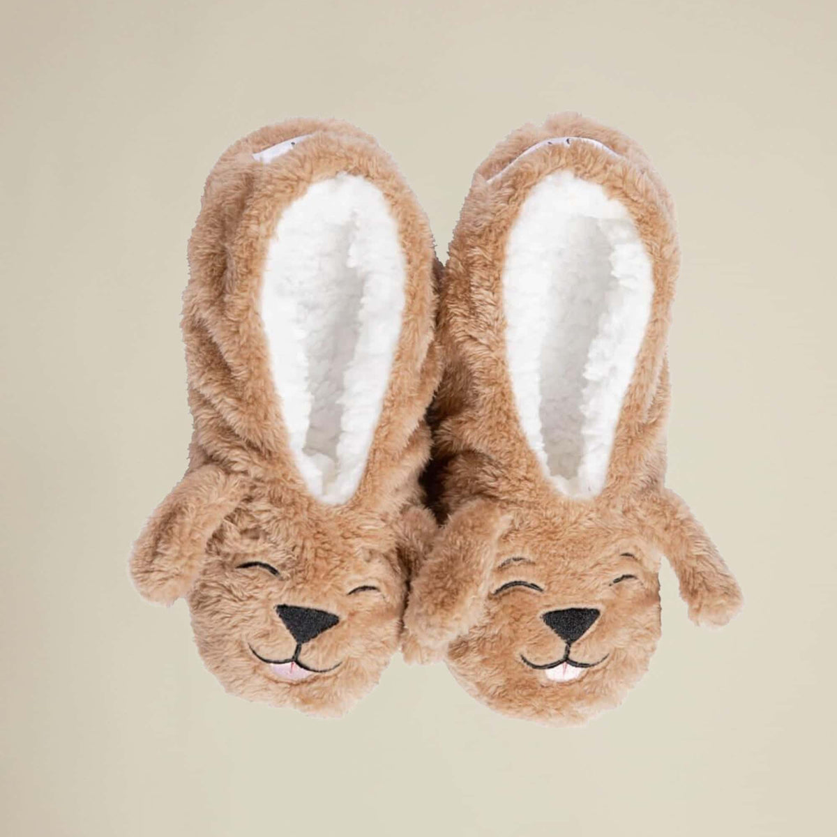 A pair of brown plush slippers designed to resemble a dog with the text 'Dog Tired' on the back.