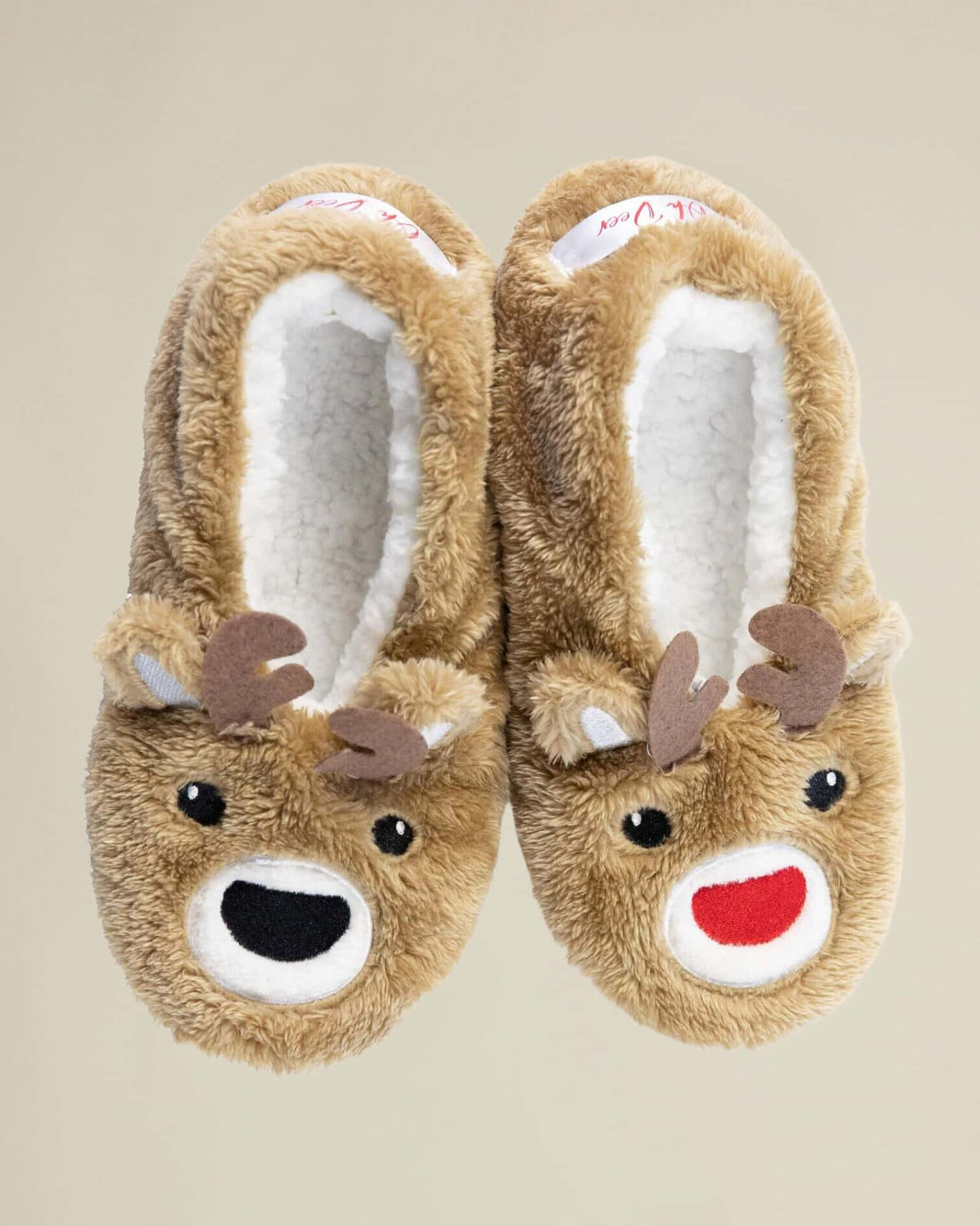 A pair of brown, plush slippers designed to resemble a reindeer with a red nose and black antlers.