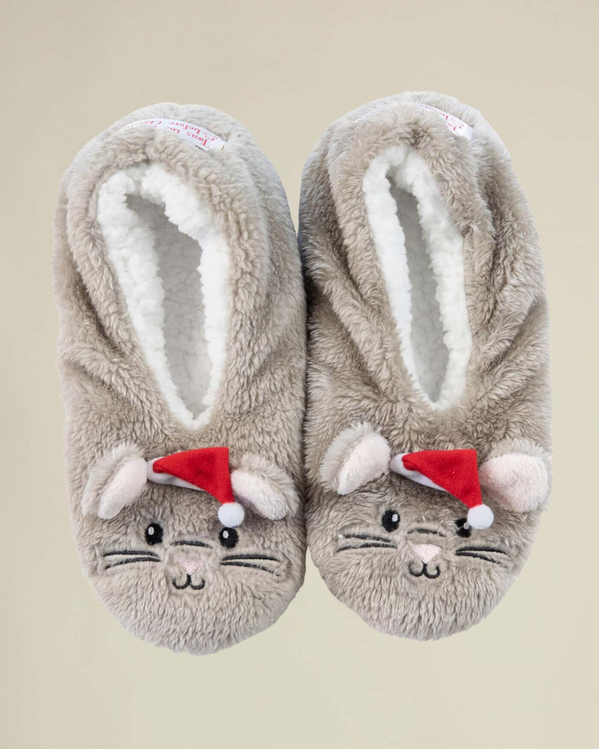 A pair of grey colored footsies featuring a cartoonish mouse design with a red Santa hat.
