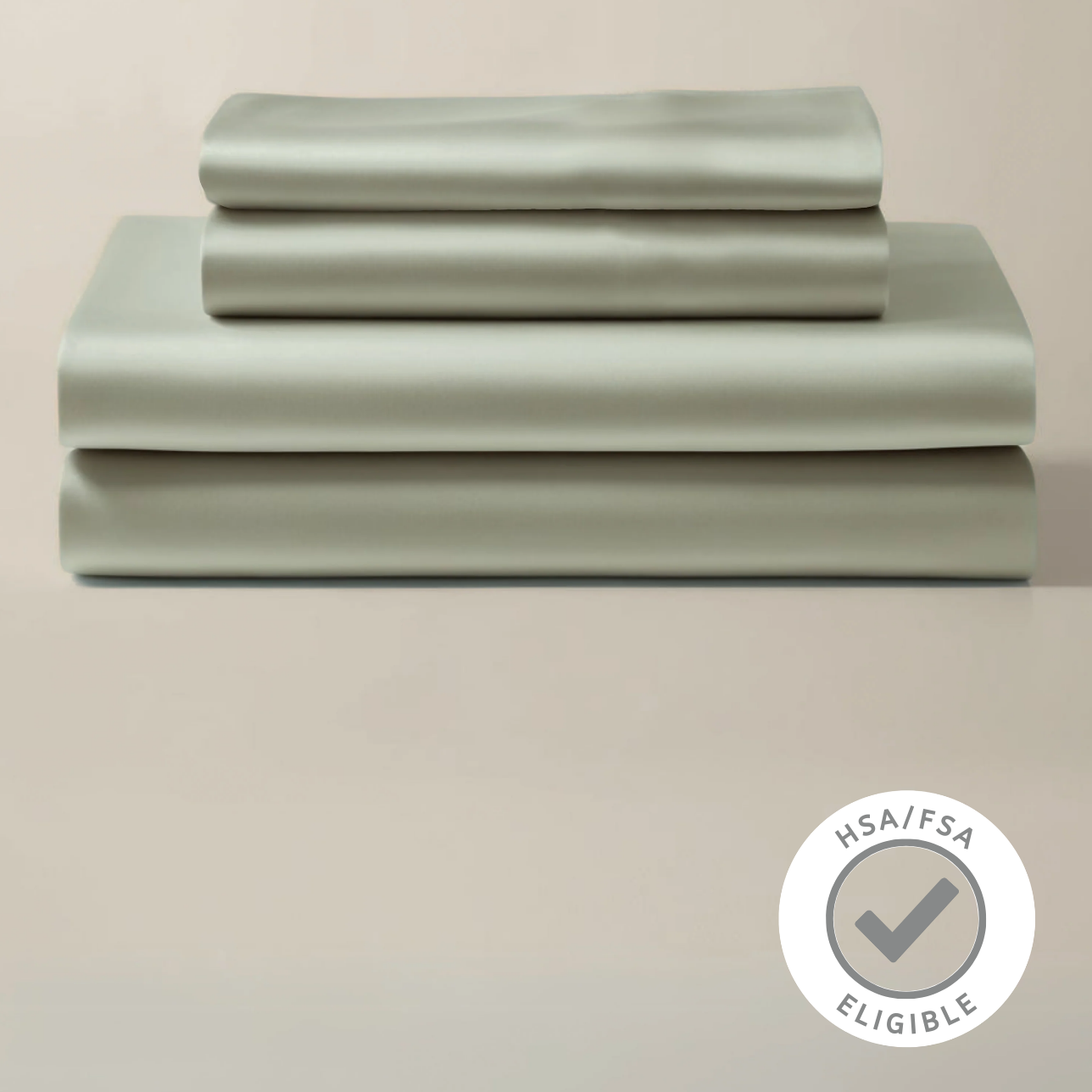 Set of light green bedding sheets on a beige background with a certification logo.