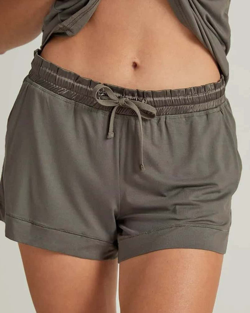 grey shorts worn by a person on a plain background