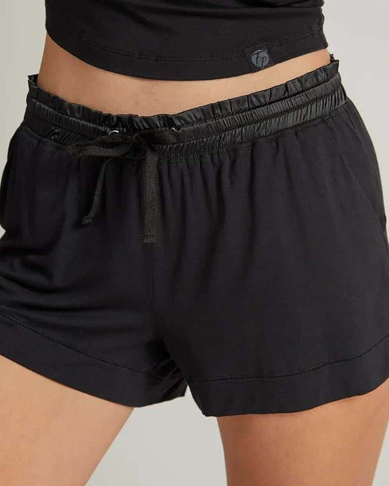 black shorts with a drawstring worn by a person on a plain background. The fabric looks light and breathable.