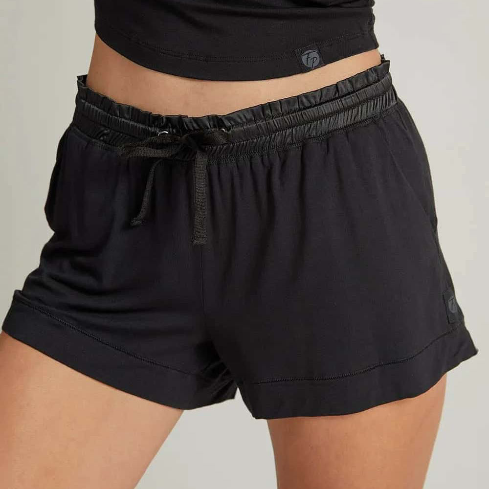 black shorts with a drawstring worn by a person on a plain background. The fabric looks light and breathable.