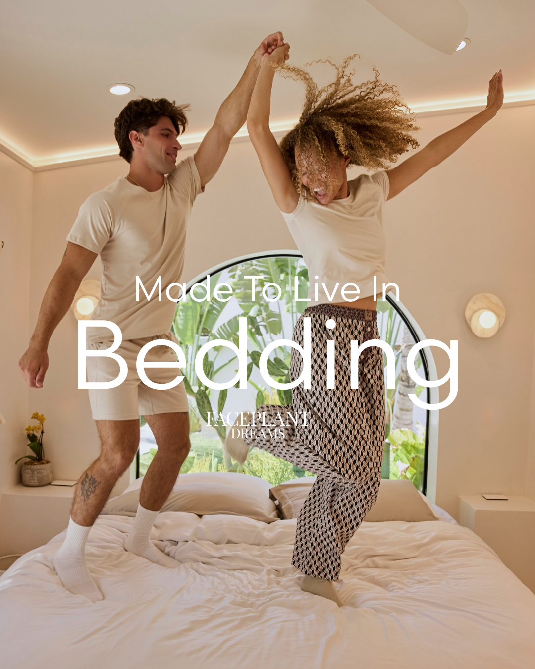 Two people jumping on a bed with 'Made To Live In Bedding' text overlay.