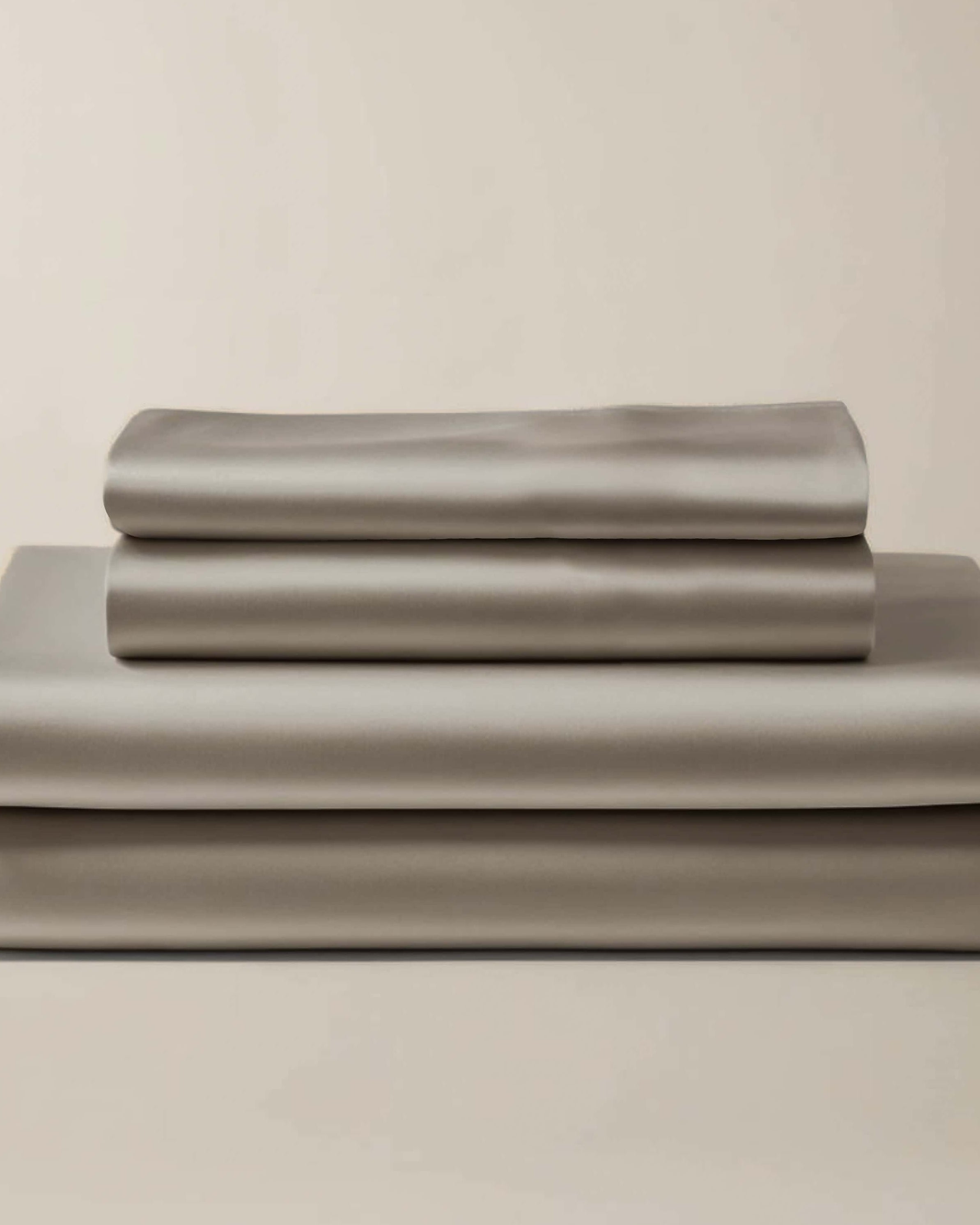 Stack of folded gray bamboo sheets and pillowcases.