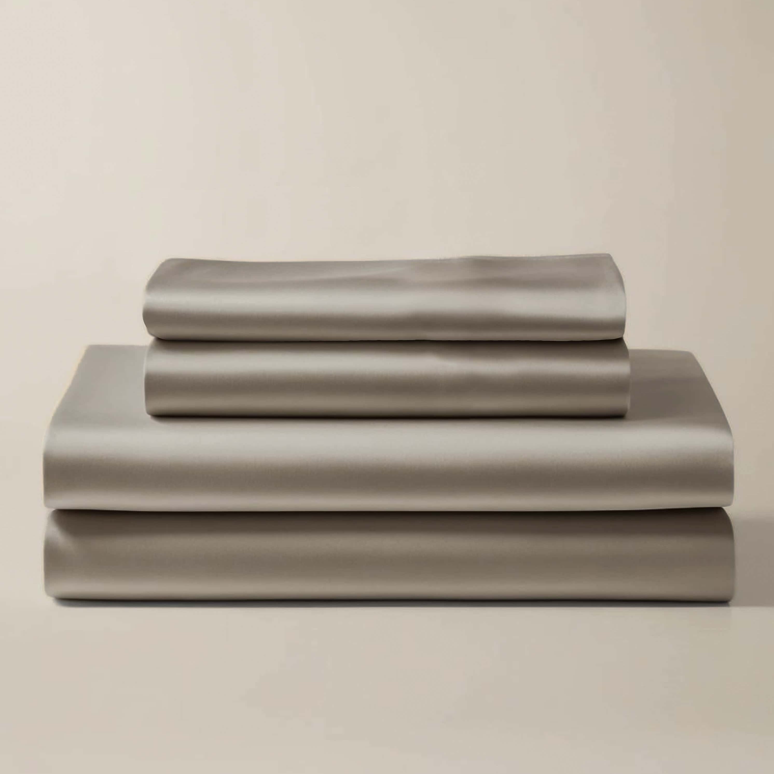 Stack of folded gray bamboo sheets and pillowcases.