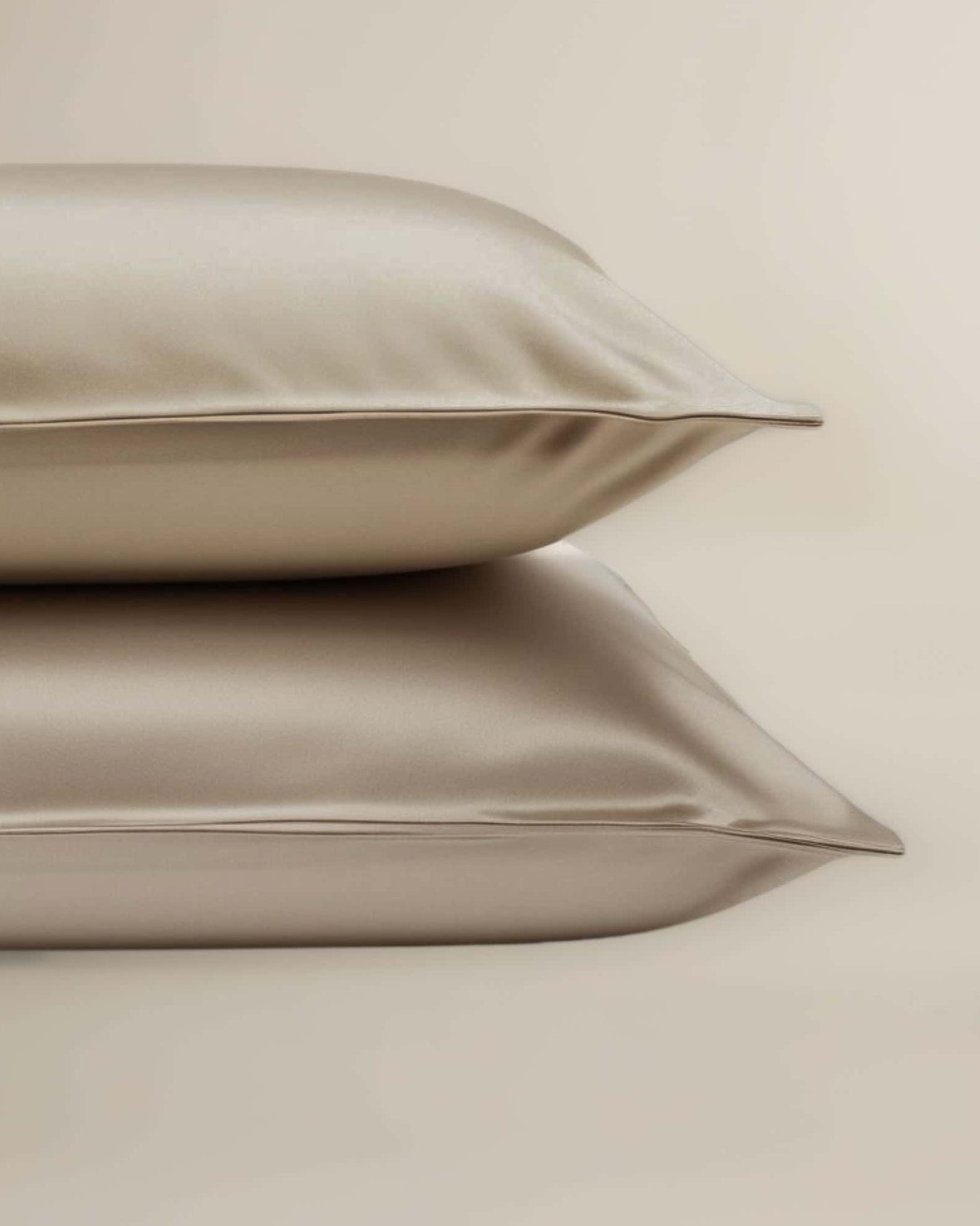A set of beige bamboo pillowcases neatly stacked on top of each other.