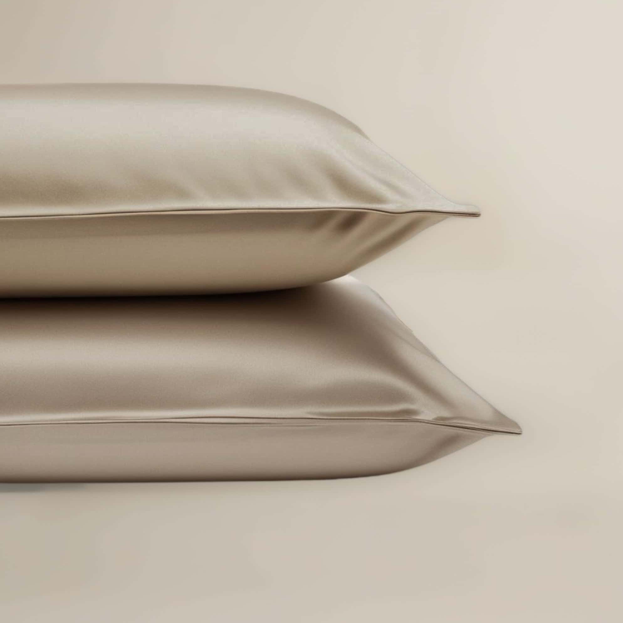 A set of beige bamboo pillowcases neatly stacked on top of each other.
