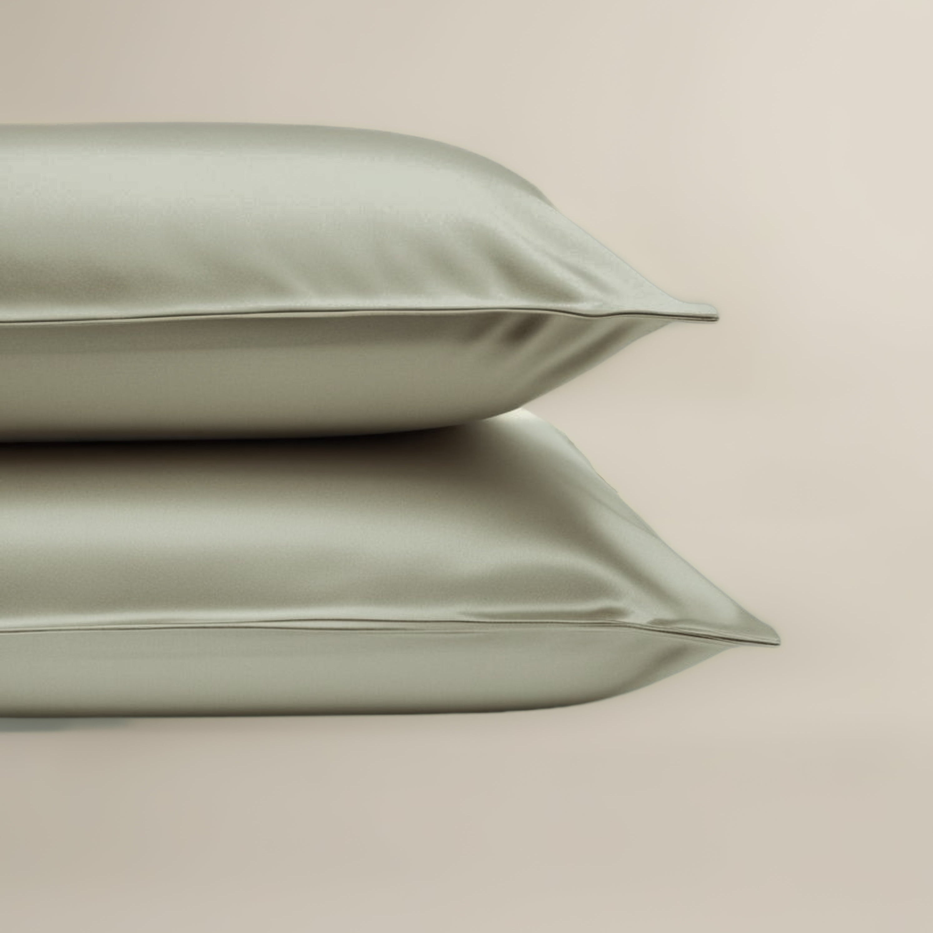 Two green pillows on a beige background