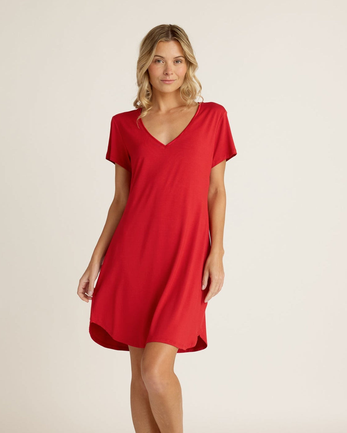 Woman wearing a red dress against a plain background