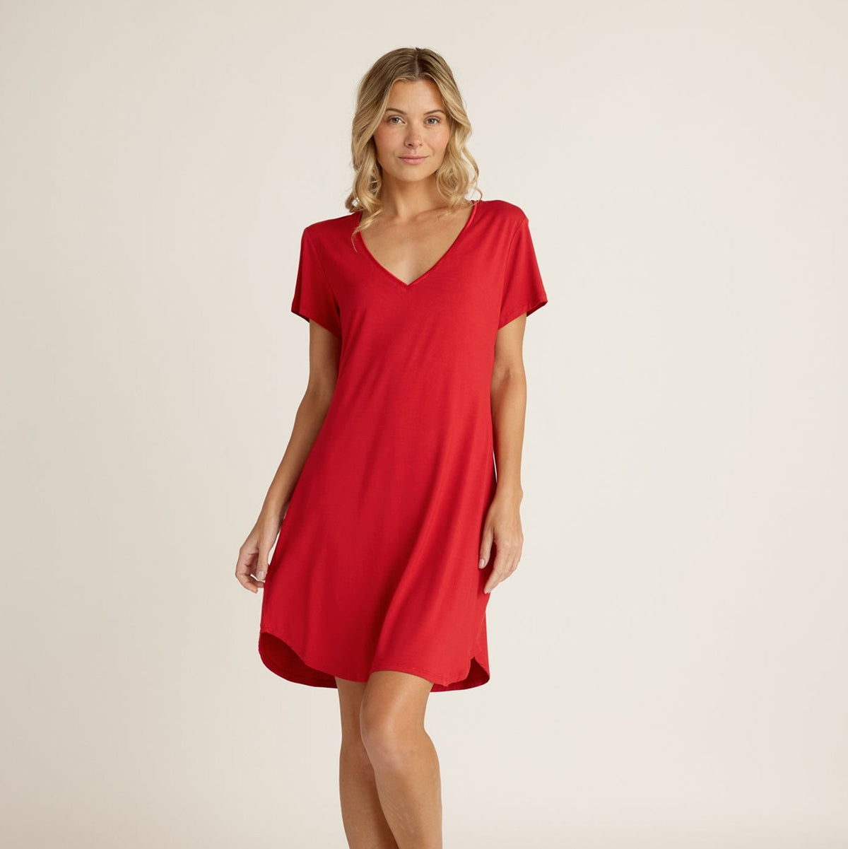 Woman wearing a red dress against a plain background