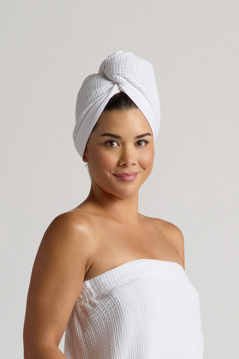 Woman wearing a white Spa Wrap wrapped around her body and hair wrap  on her head