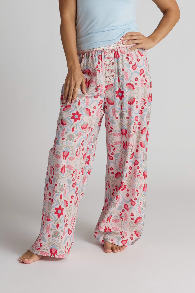 Person wearing floral pajama pants on a plain background