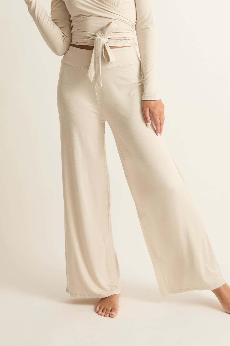 A model wearing beige lounge pants with a mock waistband in a relaxed fit.