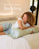 Woman lying on a bed with a green body pillow, smiling. text voverlay reads 'HSA/FSA Eligible Bedding - Faceplant Dreams'