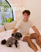 Man sitting on a bed with a dog, with 'Made To Live In Bedding' text overlay.