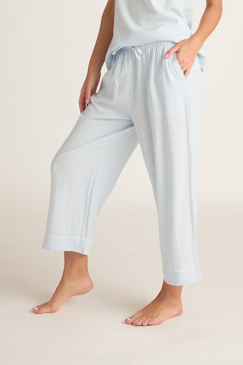 Light blue pajama set with pants and top on a neutral background